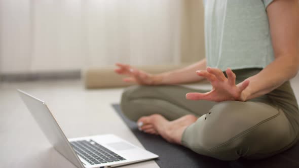 Unrecognizable Woman Teaching Yoga Class via Video Call