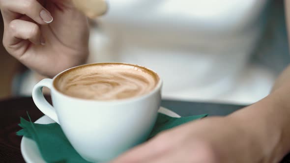 Girl Stirs Coffee with a Spoon, Dripping Drops, Close-up, Slow Motion