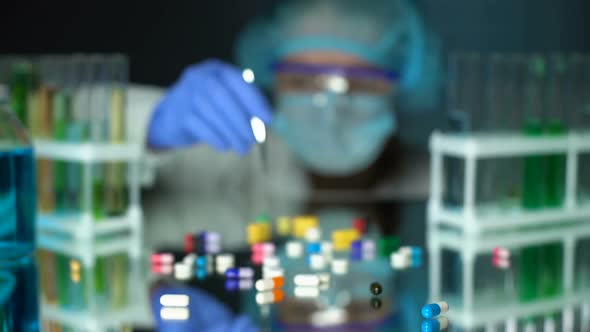 Lab Assistant Analyzing Medication Capsules, Counterfeit Pharmaceuticals, Study