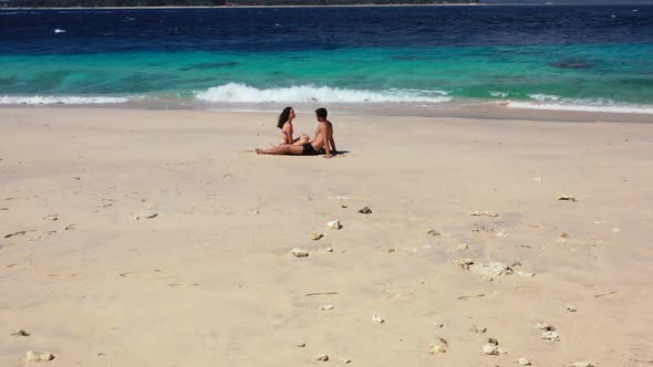 Young couple relax on paradise bay beach wildlife by blue water with white sand background of Gili M