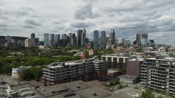 Aerial view by drone of condominium, residential area close to downtown Montreal, approaching skyscr