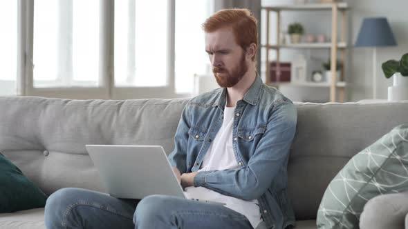 Pensive Creative Beard Man Thinking and Working on Laptop