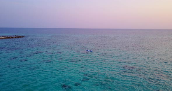 Natural flying clean view of a white sandy paradise beach and aqua turquoise water background in hig