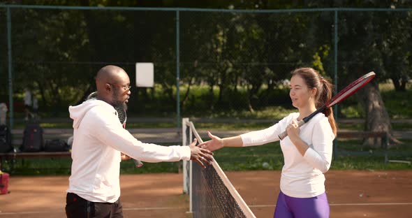 Multi Ethnic Man and Woman Handshaking Before Tennis