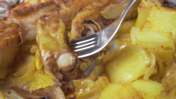 Fried meat with potatoes flavored with turmeric close-up