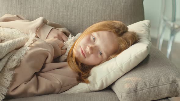 The Depressed Girl is Sad Alone in the Living Room of the House