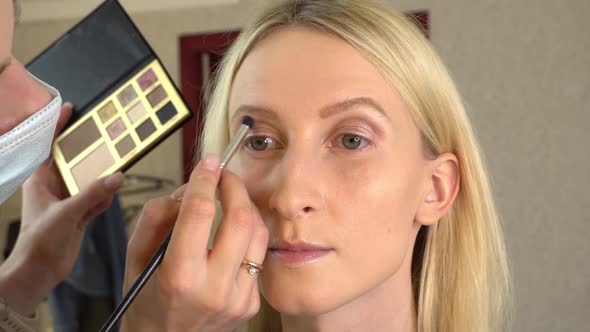 Stylistmakeup Artist Master Applies Eye Shadow to a Young Model