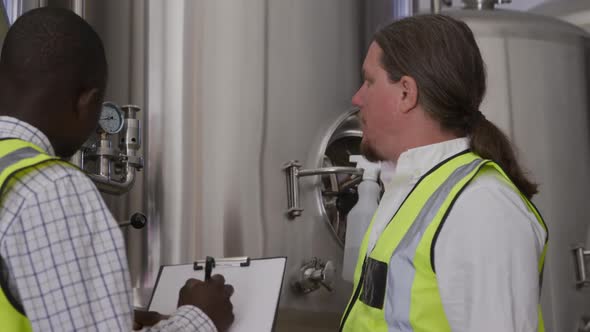 Caucasian and African American man working in a microbrewery