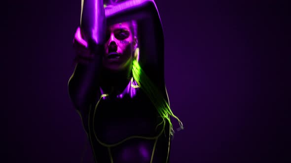 Front View Slim Woman in Futuristic Costume with Makeup Posing Dancing Robot Dance in Purple Neon