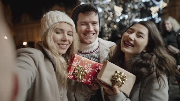 Selfie Portrait of Group of Teenagers Smiling and Having Great Time on Christmas Eve Outside