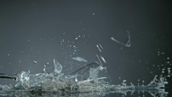 Breaking Glass with Champagne on Grey Background at 1000 Fps