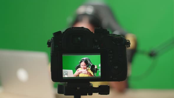 Camera Display Of Asian Kid Girl Playing Video Game With Phone While Live Stream On Green Screen