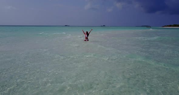 Sexy beauty model on holiday having fun at the beach on clean white sand and blue background 4K