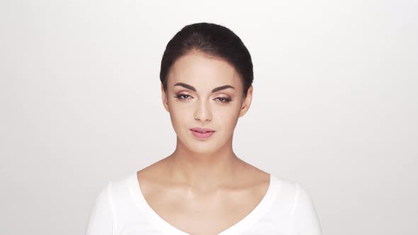 Studio portrait of young and beautiful brunette woman over