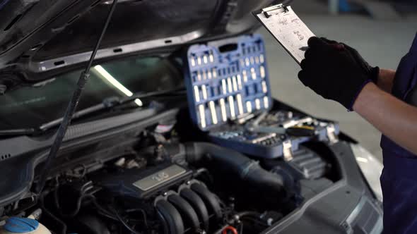 Mechanic repairman inspecting car closeup