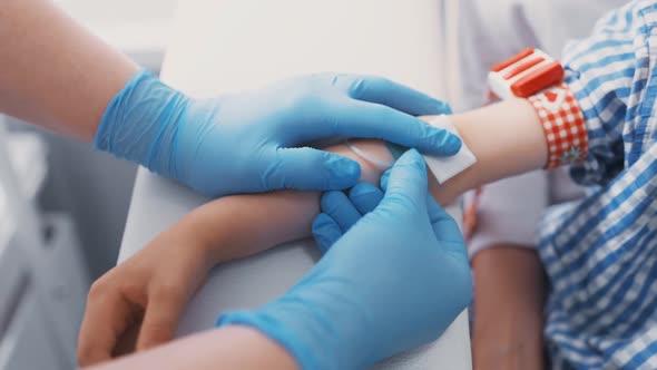Doctor or Nurse Takes Blood From a Vein in a Child of a Boy