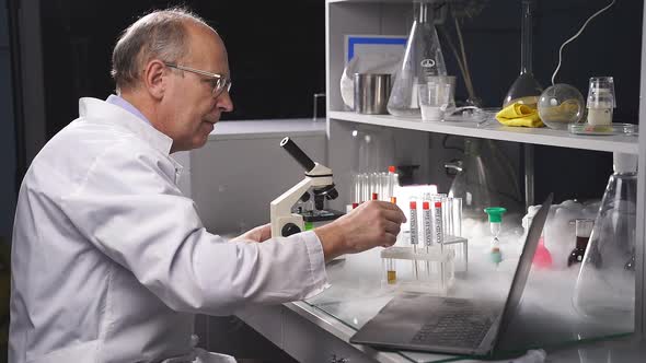 Scientist Holding Test Tube with Sample for COVID19 Test