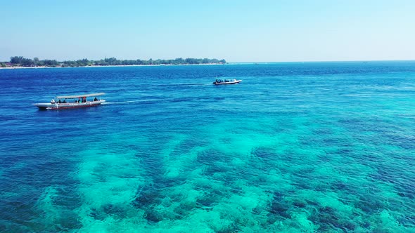 Wide angle above copy space shot of a white sandy paradise beach and blue sea background in best qua