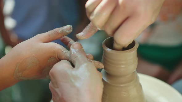 Hands of Potter Teaches the Child How To Make Pots. Concept - Transfer of Experience, Training