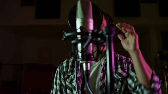 Male singer singing in a music studio