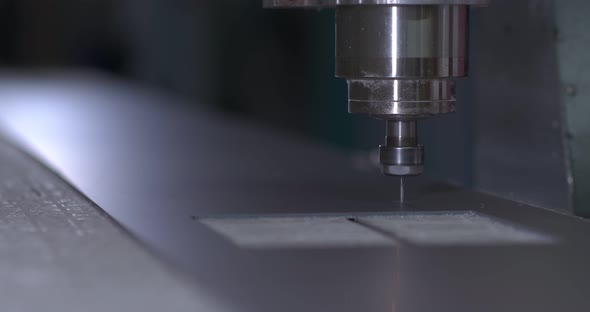 Cutter Lowers the Drill Into a Sheet of Metal and Begins to Cut the Product CNC