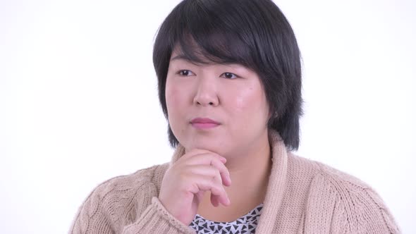 Face of Happy Overweight Asian Woman Thinking and Looking Up Ready for Winter