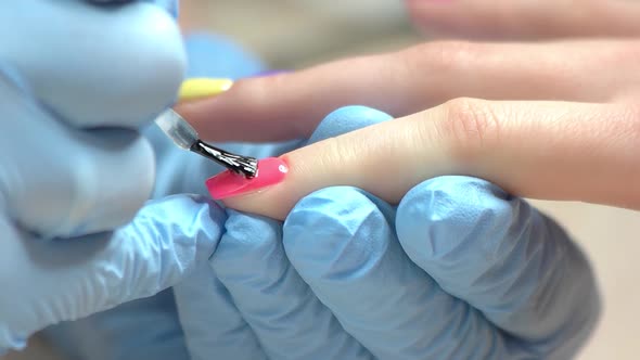 Close Up Hand Covering Nail with Fixer.