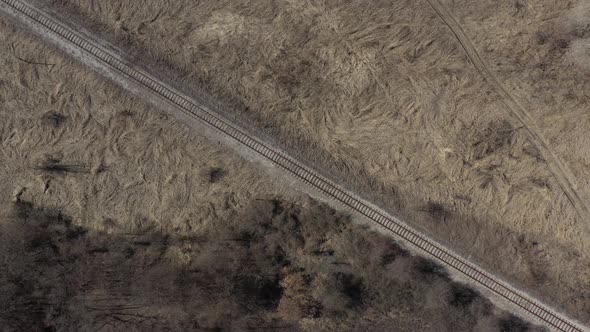 Morning sun over the field with railroad track 4K aerial footage