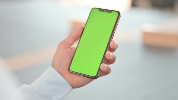 Hands of Man Using Smartphone with Green Chroma Key Screen