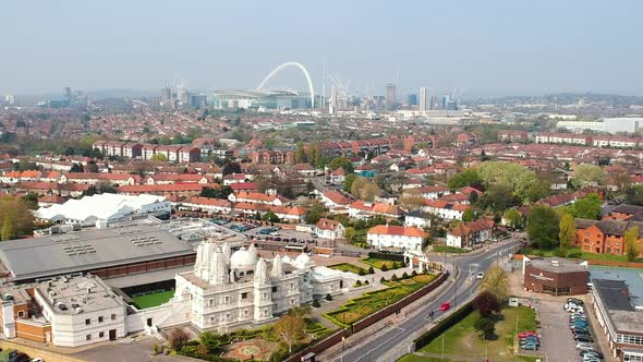 Neasden Temple in Brent, London with Wembley Stadium. BAPS Shri Swaminarayan Mandir is one of the la