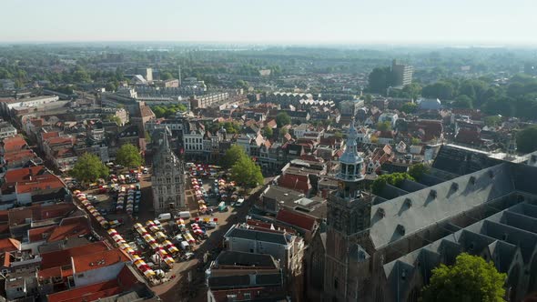 Aerial View Of Famous Cheese Market Outside The Old Town Hall Of Gouda In Netherlands. Saint-John Ch