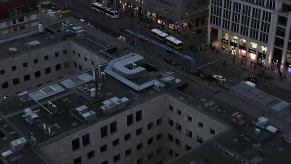 AERIAL: Slowly Flying Over Center of Berlin Germany Intersection with Car Traffic at Sunset 