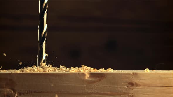 Wood is Drilled with a Drill with Sawdust