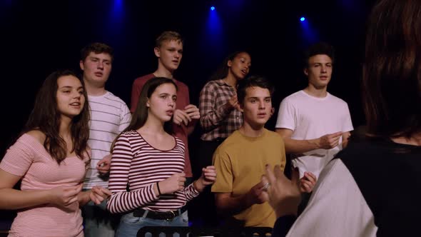 Teenagers rehearsing in a theatre