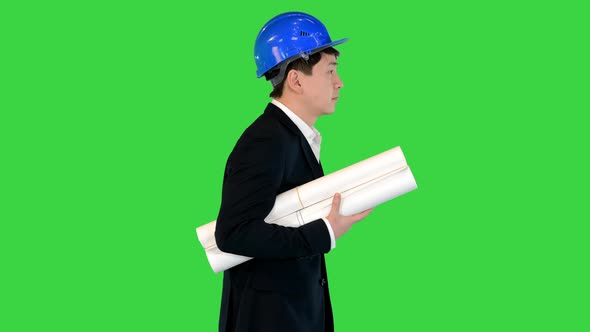Asian Engineer with Blueprints Walking on a Green Screen Chroma Key