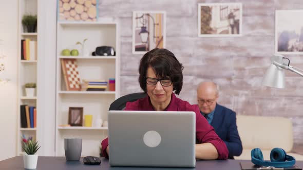 Excited Old Woman While Using Laptop in Living Room