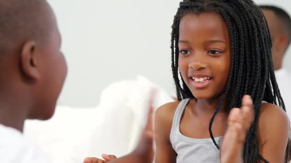 Children playing on bed