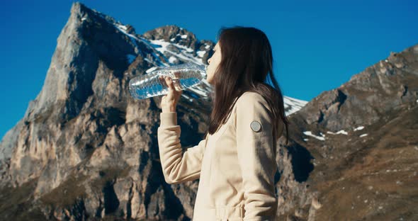 Young Adult Woman Drink Water on Mountain Travel