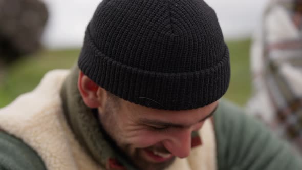 Smiling Man In Woolly Hat Laughing And Looking Away