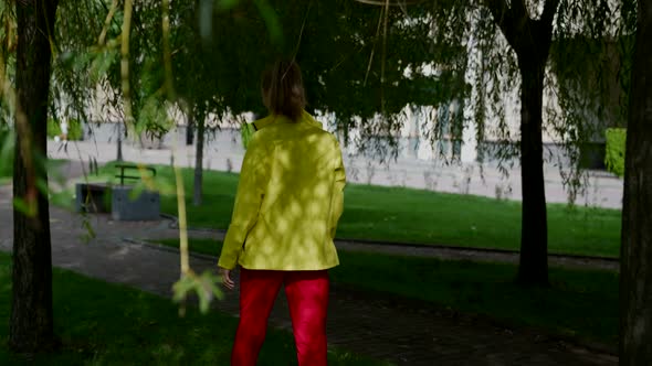 Joyful Woman is Walking in Park in Summer Day Resting and Enjoying Good Weather