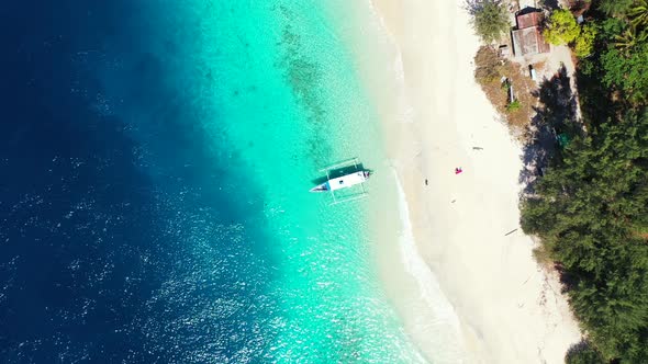 Natural birds eye tourism shot of a paradise sunny white sand beach and aqua turquoise water backgro