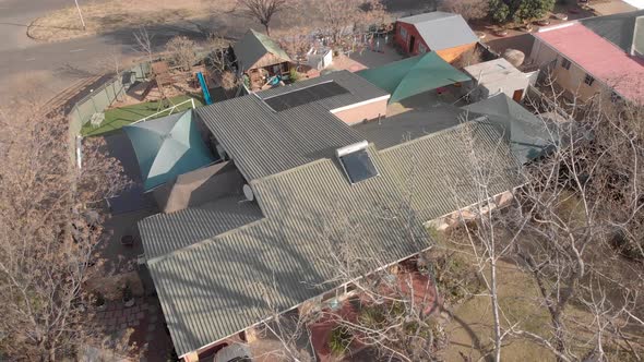 AERIAL reverse reveal shot of a house in south africa during winter time