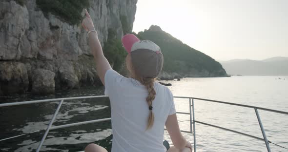 Happy woman enjoying summer vacation on a yacht.