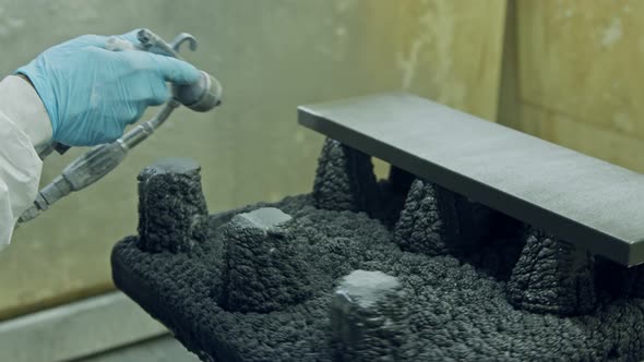 Slow motion of a worker painting kitchen wood doors using spray paint