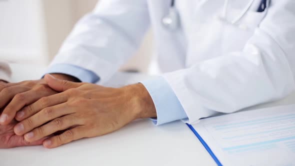 Hands of Doctor Supporting Senior Woman at Clinic