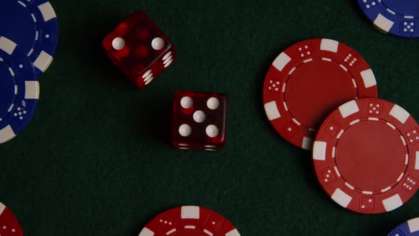 Rotating shot of poker cards and poker chips on a green felt surface - POKER 026