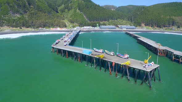 port or caleta meguellines, constitucion chile drone shot sunny day with fishing boats orbital drone