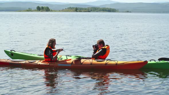 Tourists Photographing in Kayak