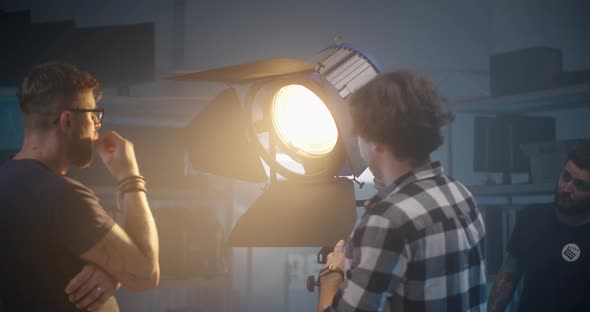 Costumer Checking Light in Video Equipment Store