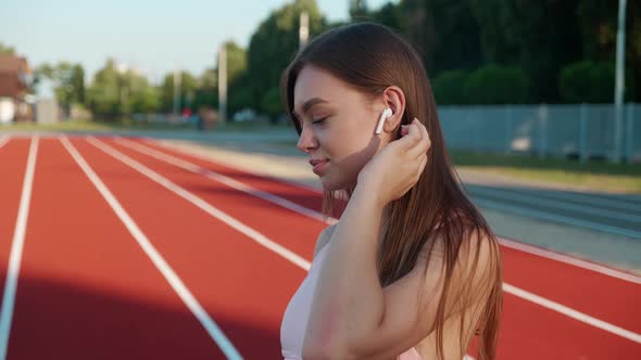 Confident Sports Woman Turning on Music and Going for a Run